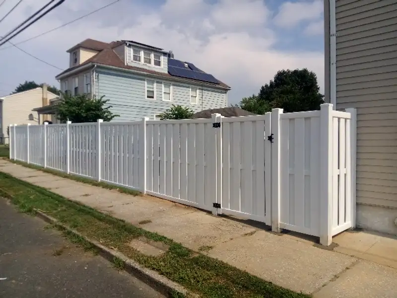 White vinyl residential fence installation by Fencing By Excellence near Holmdel, Monmouth County NJ