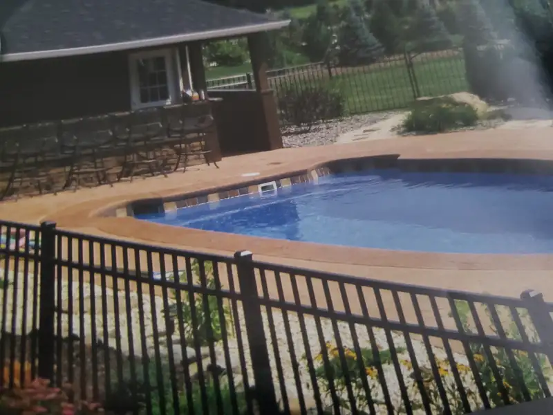 Black aluminum pool safety fence around in-ground pool by Fencing By Excellence near Tinton Falls, Monmouth County NJ