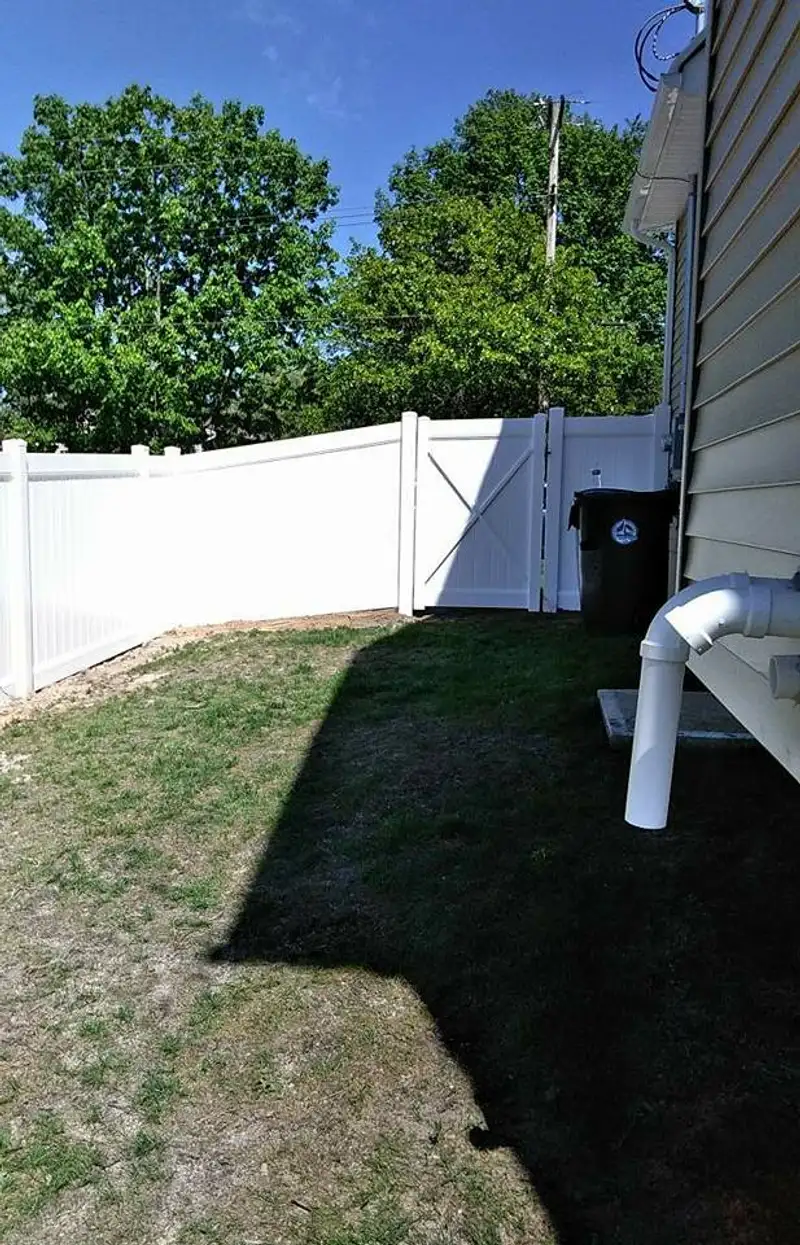 Vinyl fence with pool area visible by Fencing By Excellence near Hazlet, Monmouth County NJ
