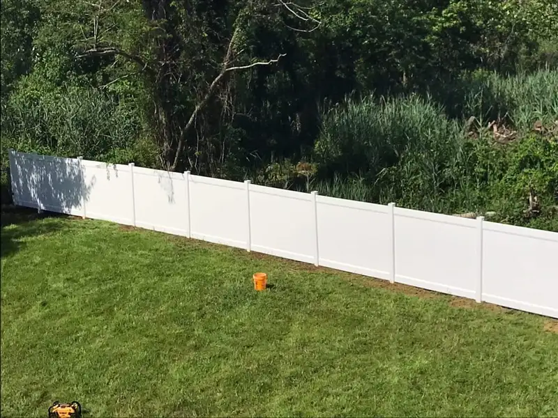 White vinyl fence long property line view by Fencing By Excellence near Atlantic Highlands, Monmouth County NJ