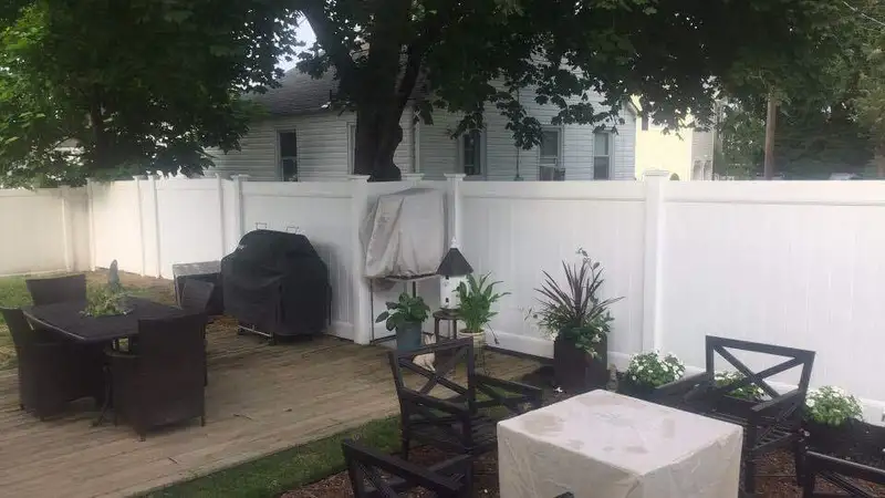 White vinyl fence with ornamental gate hardware by Fencing By Excellence near Howell, Monmouth County NJ