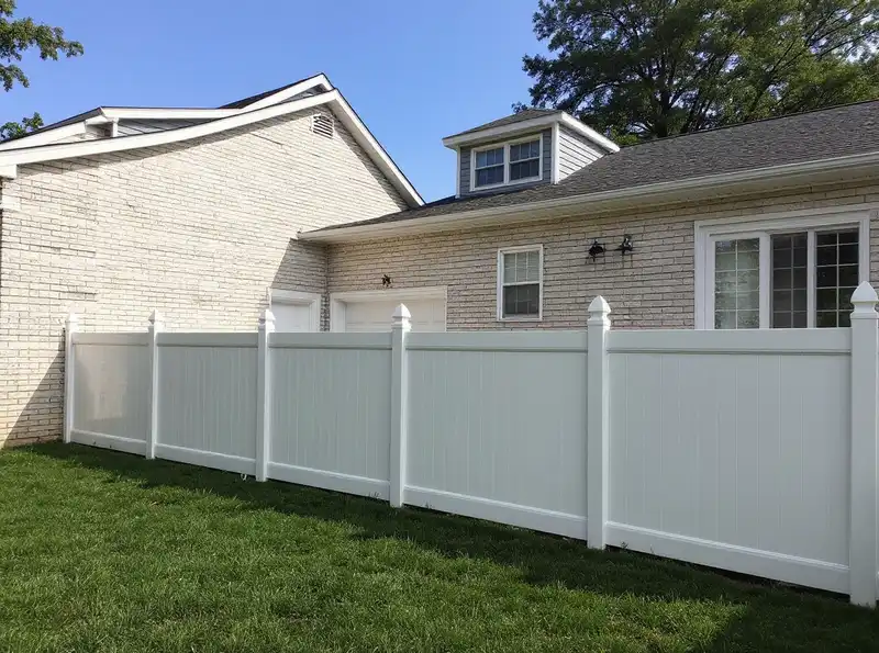 White vinyl privacy fence with lattice top in a Monmouth County NJ suburban yard
